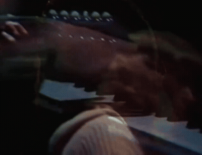 Man In Hooded Jacket Playing Guitar On Stage GIF