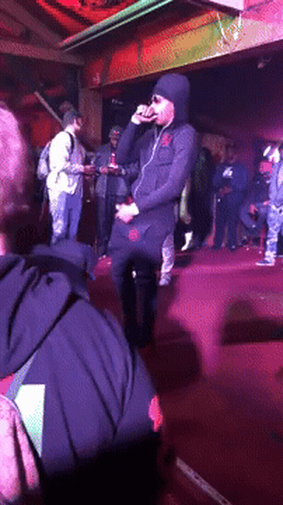 Man In Hooded Jacket Singing Into Microphone GIF