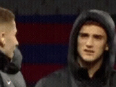 Man In Hooded Jacket Standing In Front Of Man In Suit GIF