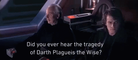 Man In Hooded Jacket Talking In Dark Room GIF