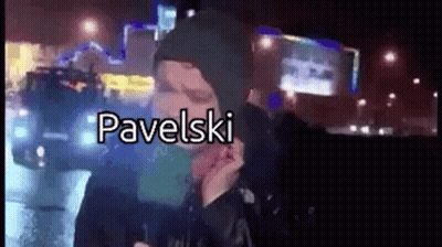 Man In Hooded Jacket Talking On Cell Phone At Night GIF
