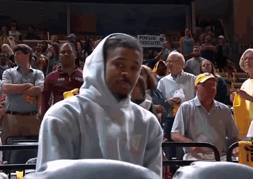 Man In Hooded Sweatshirt In Front Of Focus Execute Sign GIF