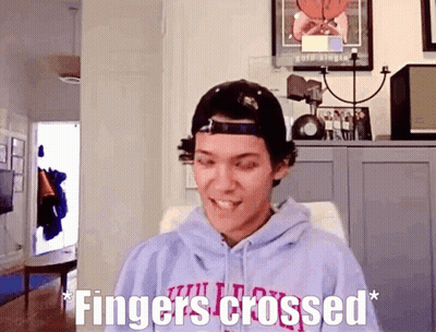 Man In Hoodie And Hat Fingers Crossed GIF