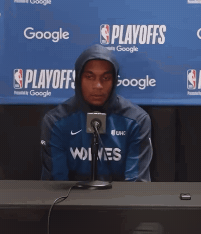Man In Hoodie At Table With Google Banner GIF