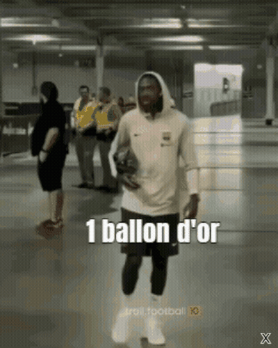 Man in Hoodie Carrying Soccer Ball Says 1 Ballon d'Or