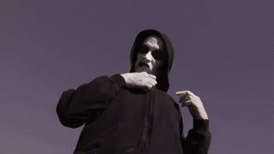 Man in Hoodie Holding Spoons in Pocket