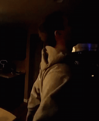 Man In Hoodie In Dark Room GIF
