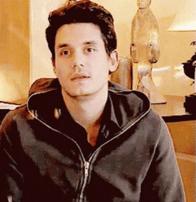 Man In Hoodie Looking At Camera With Statue GIF