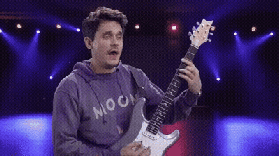 Man In Hoodie Playing Electric Guitar On Stage GIF