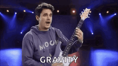 Man In Hoodie Playing Guitar Says Gravity GIF