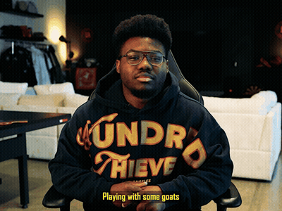 Man In Hoodie Playing With Goats GIF
