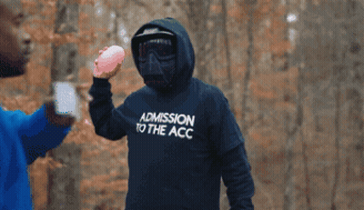 Man in Hoodie Saying ADN Holding Pink Ball