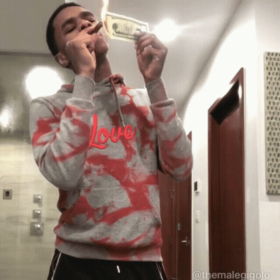 Man In Hoodie Saying Love Lighting Dollar Bill GIF