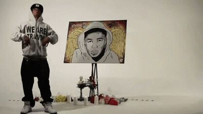 Man In Hoodie Saying We Are Trainin In Front Of Painting GIF
