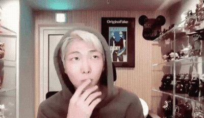 Man In Hoodie Smoking Cigarette In Toy Room GIF