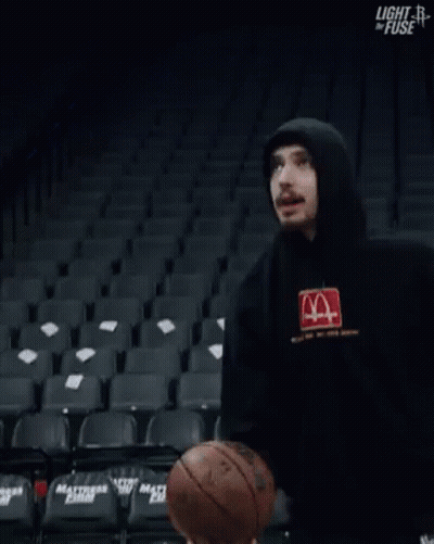 Man In Hoodie Standing In Empty Basketball Stadium GIF