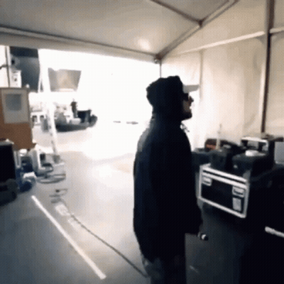 Man In Hoodie Standing Near Microwave GIF