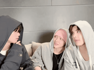 Man In Hoodie With A Talks To Two Men GIF