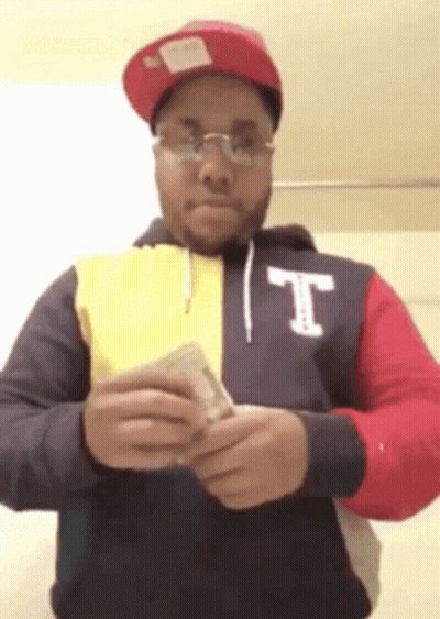 Man In Hoodie With Letter T Holding Money GIF