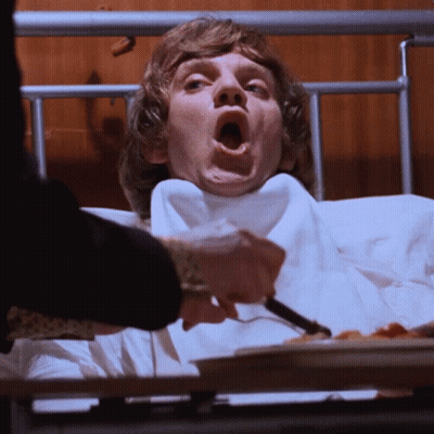 Man In Hospital Bed Being Fed GIF