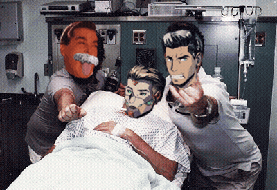 Man In Hospital Bed Surrounded By Two Men GIF