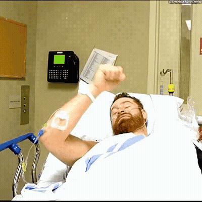 Man In Hospital Bed With Fist Up GIF