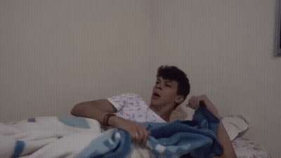 Man In Hospital Gown Screaming On Bed GIF