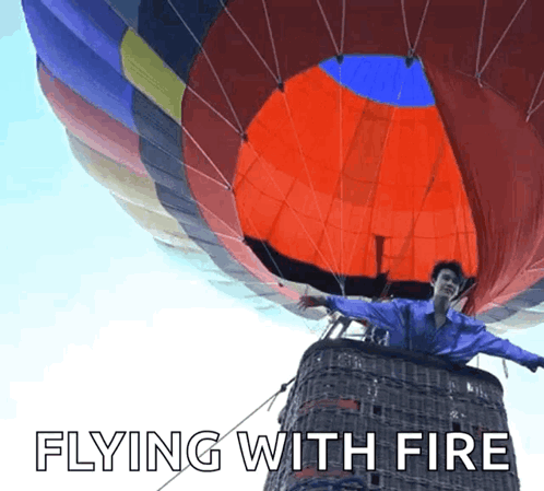 Man In Hot Air Balloon Flying With Fire GIF