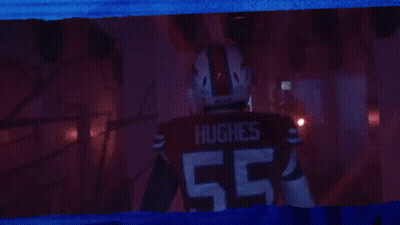 Man In Hughes Jersey Standing In Dark Room GIF