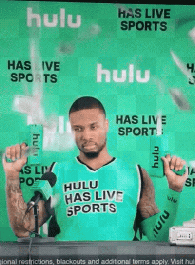 Man In Hulu Has Live Sports Jersey Holding Two Boxes GIF