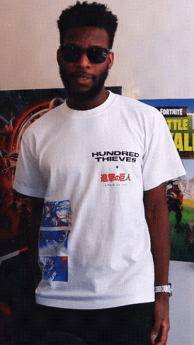 Man In Hundred Thieves T-Shirt In Front Of Fortnite Poster GIF
