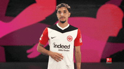 Man In Indeed Shirt On Pink Background GIF