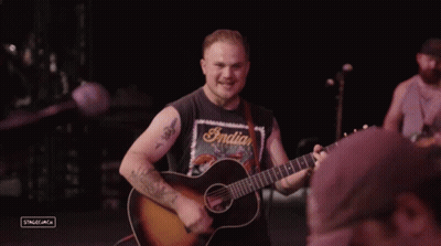 Man In Indian Motorcycles Shirt Playing Guitar GIF