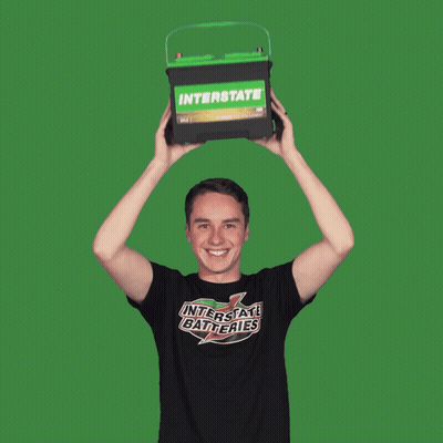 Man In Interstate Batteries Shirt Holding Green Battery Over Head GIF