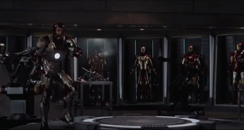 Man In Iron Man Suit With Other Iron Man Suits GIF