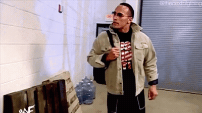Man In Jacket And Sunglasses Walking Down Hallway With Backpack GIF