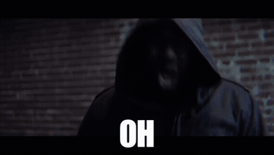 Man In Jacket In Front Of Brick Wall Saying Oh GIF