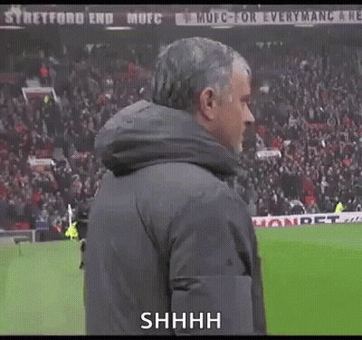 Man In Jacket On Soccer Field Saying Shhhh GIF