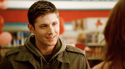 Man In Jacket Smiling Talking To Woman GIF