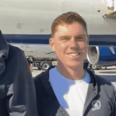 Man In Jacket With Letter D Smiling GIF