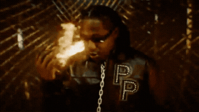 Man In Jacket With Letter P Standing In Front Of Fire GIF
