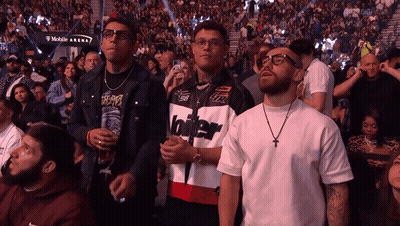 Man In Jacket With Number 96 In Front Of Crowd GIF