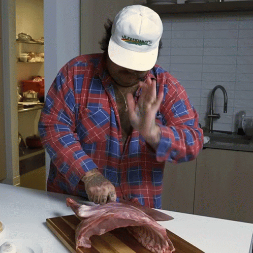 Man In Jacksonville Hat Cutting Meat GIF