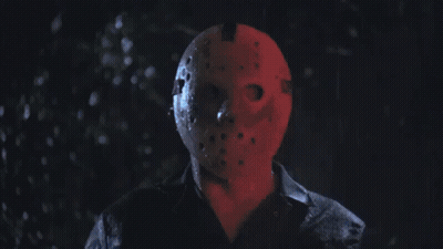 Man In Jason Voorhees Mask In Dark Rain GIF