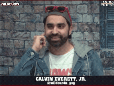 Man In Jaws Shirt And Denim Jacket Talking On Phone GIF