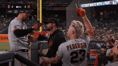 Man In Jersey 23 In Front Of Detroit Roots Sign GIF