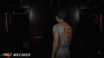 Man In Jersey Number 16 Praying In Dark Room GIF