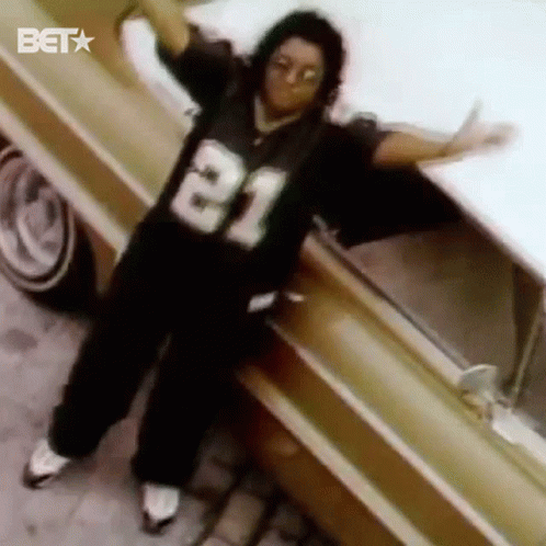 Man In Jersey Number 21 Standing Next To Car GIF