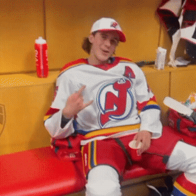 Man In Jersey With Letter J Sitting On Bench GIF