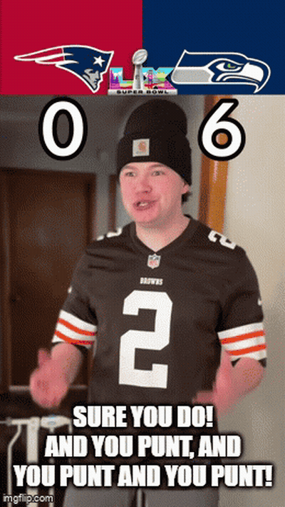 Man In Jersey With Number 2 In Front Of Patriots And Seahawks Banner GIF
